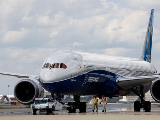 FILE - In this Friday, March 31, 2017, file photo, Boeing employees walk the new Boeing 787-10 Dreamliner down towards the delivery ramp area at the company's facility in South Carolina after conducting its first test flight at Charleston International Airport in North Charleston, S.C. The Boeing Co. reports earnings, Wednesday, April 26, 2017. (AP Photo/Mic Smith) (Photo: Mic Smith, AP)