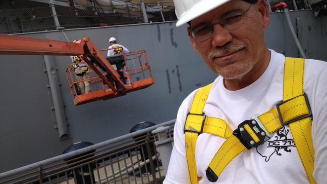 Union painter Jeff Alcott of Mount Holly, one of four painters for the Battleship New Jersey, hull painting project Monday at the museum ship’s dock on the Delaware River in Camden. The International Union of Allied Painters and Trades, District Council 711 of New Jersey, is donating union time and the materials to paint the 887.6-foot long ship, built during World War II at the Philadelphia naval shipyard and the Navy’s most militarily decorated battleship.