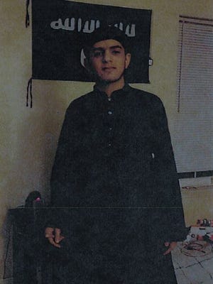 Akram I. Musleh in front of the ISIL flag he purchased online.