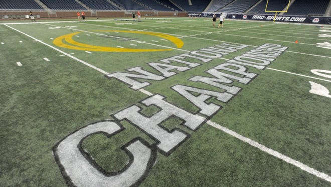 The midfield area at Ford Field is decorated with the National Championship logo on Tuesday during the MAC Youth Football Clinic.