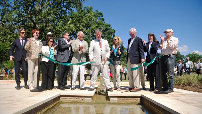 Mayor Karl Dean cuts the ribbon during a ceremony at Musicians Corner in Centennial Park in Nashville, Tenn. August 27, 2015. The historic Cockrill Spring (which was been buried and drained to a sewer for a century) is back to the surface and adds a water feature. 