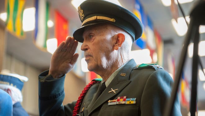 Guest speaker and Korean War Veteran Army Capt. A.T. Jackson salutes during the 2015 Veterans Day Celebration at Rowan College at Gloucester County. Wednesday, November 11, 2015.
