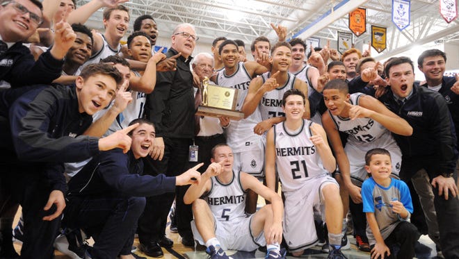 St. Augustine players and coaches pose for a picture with the Non-Public A boys basketball championship trophy. The Hermits finished as the Courier-Post's Team of the Year.
