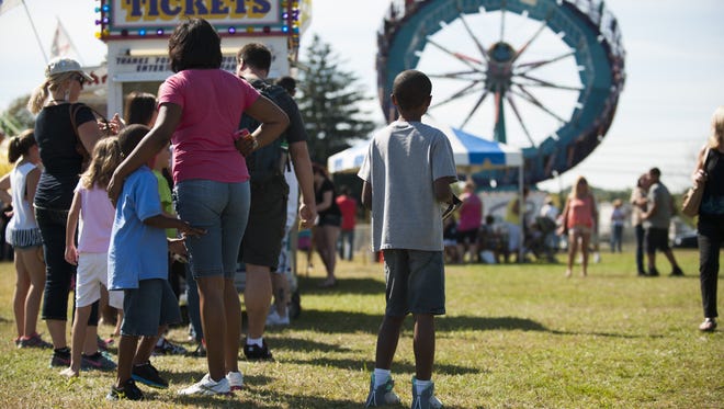 A family waits in line for tickets at the 2014 Camden County Fair. The fair returns to Camden County College's Blackwood campus this weekend.