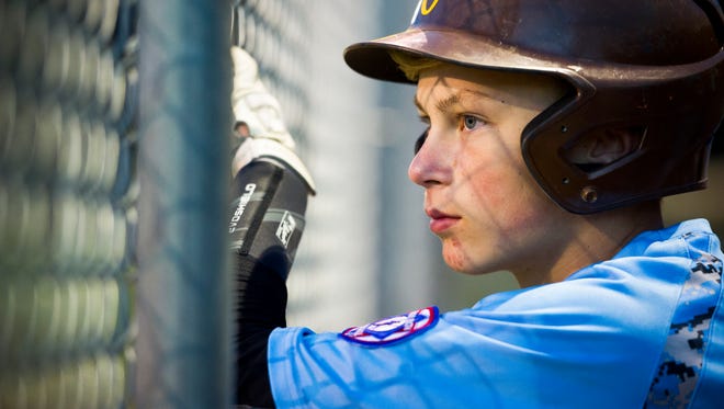 Isaac Carter, 16, of Evansville, watches his teammates from the dugout on the Mickey Martin baseball field at McCutchanville Community Park in Evansville, Thursday, Oct. 13, 2016. The Mickey Martin baseball field could be in jeopardy as the Evansville Vanderburgh School Corp. finalizes plans for a new North Side elementary school.