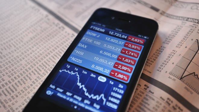 Stock index prices are displayed on a phone in Milan, on July 23, 2012. (AFP PHOTO/GIUSEPPE CACACE/AFP/GettyImage)