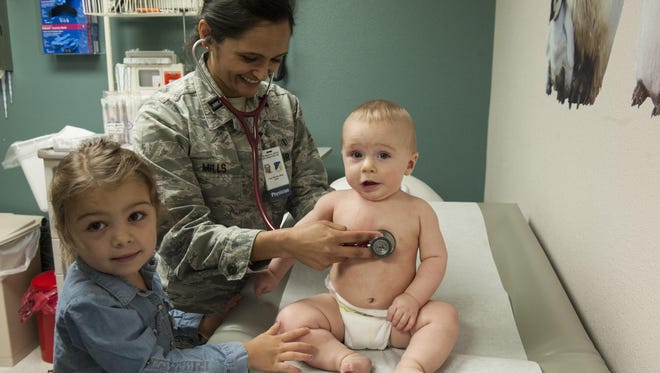 Capt. Manisha Mills, a 49th MDOS pediatrician, checks her patient's heart rate March 29, 2017 at Holloman Air Force Base, N.M. Mills' framework consists of about 20-23 appointments per day and in between those appointments, she takes walk-in clients.