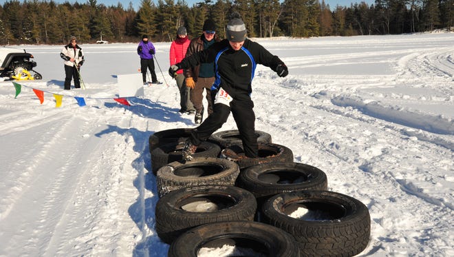 Competitors complete an obstacle during the Arctic Warrior Race in St. Germain.