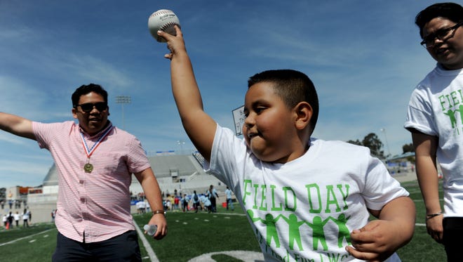 Gabilan School student Martin Madrid tosses a ball during field day on Friday. 