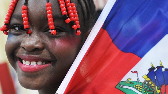 
Imane Abdou-Saleye, 7, holds a Haitian flag at the Haitian Flag Day celebration at St. Michael the Archangel Church on May 18, 2014.
