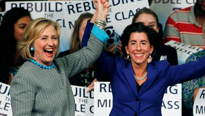 Hillary Rodham Clinton, left, with then-Democratic gubernatorial nominee (and now Governor-elect) Gina Raimondo of Rhode Island, right, while campaigning for her at Rhode Island College in Providence, R.I.