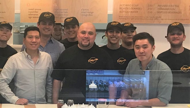 From left to right: Kasper Hsu; Jesus Reza (wearing hat, behind Hsu), El Paso Pokéworks franchise owner; Ruben Meraz, manager of El Paso Pokéworks; Peter Yang (gray shirt), and some of the employees of the new Pokeworks restaurant in West El Paso. Hsu and Yang are co-founders of the California-based chain.