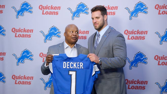 Taylor Decker and Jim Caldwell pose for pictures Friday in Allen Park.