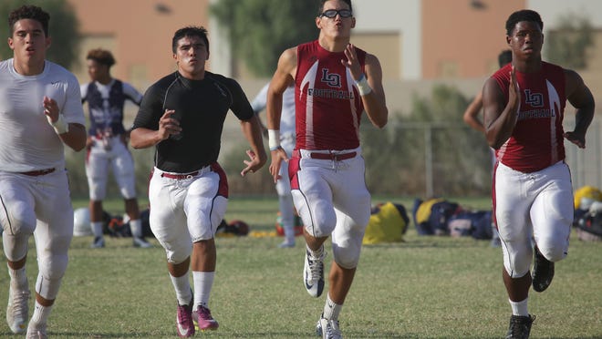The La Quinta High School football team runs during practice, Wednesday, August 19, 2015.