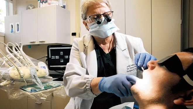 Dentist Marianne Day works on an unidentified patient at her office, the Mesilla Valley Center for Dental Medicine. 608 S. Alameda Blvd. “What people don’t realize is that the older you get — medications, aging, dryer mouth, root exposure — cavities then become a problem for adults,” Day said.