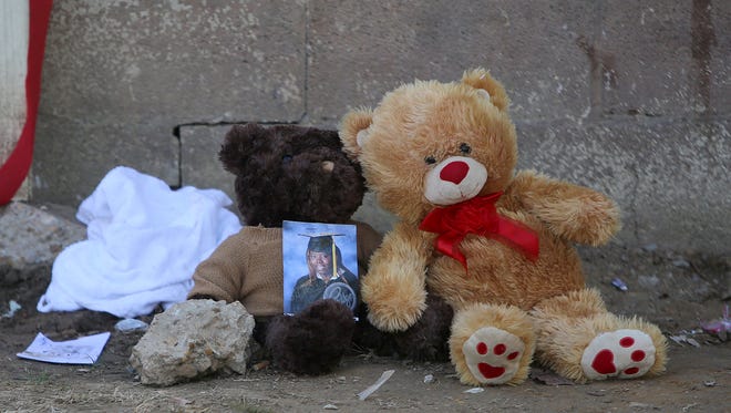 A photo of Shanice Amerson is seen on top of a teddy bear outside of the scene of a shooting, where one person was killed and six others were wounded, in Dyersburg, Tenn., on Friday, Nov. 18, 2016.