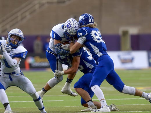 Van Meter's Sam Thompson and Chris Reames (87) tackle