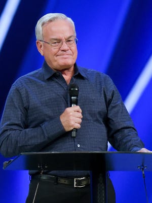 Willow Creek Community Church Senior Pastor Bill Hybels stands before his congregation, Tuesday, April 10, 2018, in South Barrington, Ill.