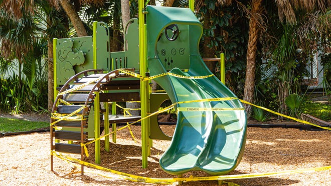 The jungle gym at George Petty Park on Washington Road in West Palm Beach is wrapped in caution tape. The playground equipment is off-limits due to the coronavirus pandemic.