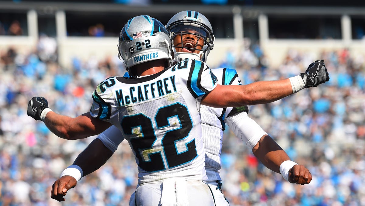 Carolina Panthers running back Christian McCaffrey celebrates with quarterback Cam Newton after scoring a touchdown in the fourth quarter at Bank of America Stadium in Charlotte, N.C. 