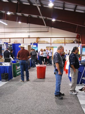 Visitors browse booths at the Four Corners Oil and Gas Conference on Wednesday at McGee Park.