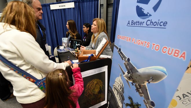 Tessie Aral, owner of ABC Charters, one of the few American companies allowed to fly directly to Cuba, chats with show attendees at the New York Times Travel Show in New York City on Jan. 25, 2015. A wave of American government officials and business people are preparing for exploratory trips to the island to gauge new opportunities following President Obama's decision to open up more trade and travel to the communist island.