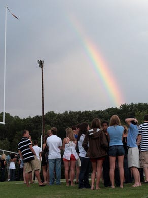 Students gather on the football field at West High School on Saturday, August 22, 2009 during a memorial for Sullivan South football player Jake Logue, who passed away the night before while playing football. 
