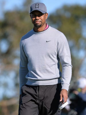Tiger Woods walks off the 10th green following a putt during the second round of the Farmers Insurance Open.
