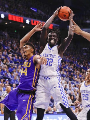 Kentucky forward Wenyen Gabriel grabs a rebound over LSU’s Wayde Sims during the first half Tuesday night at Rupp Arena in Lexington, Ky.