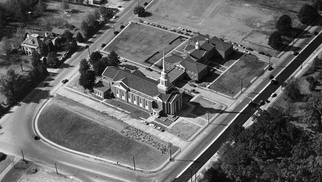 The white-steepled $875,000 sanctuary of Second Presbyterian Church (in foreground) casts a shadow like a sun dial as it waits through the hours for its opening in this photograph from November 8, 1952. The H-shaped structure in the background is the congregation's educational center and temporary sanctuary at 4055 Poplar Avenue. The church scheduled its opening for November 23.