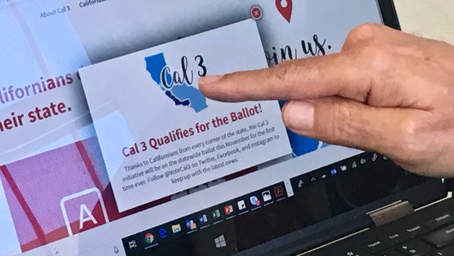 In this June 18, 2018, file photo, venture capitalist Tim Draper points to a computer screen at his offices in San Mateo, Calif., showing that an initiative to split California into three states qualified for the ballot. The California Supreme Court has blocked a measure that would divide the state in three from appearing on the November ballot. The justices on Wednesday, July 18, 2018, ordered the secretary of state not to put the initiative before voters, saying significant questions have been raised about its validity.