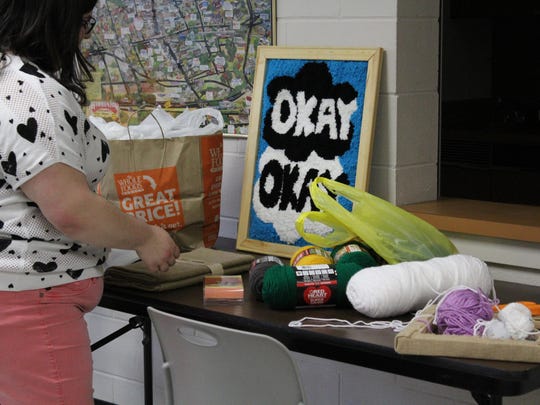 Hammonton librarian assistant Erica Villani prepares for the punch rug project during Makers Day on Saturday.