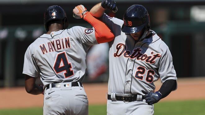 Detroit Tigers' C.J. Cron (26) celebrates with Cameron Maybin (4) after hitting a two-run home run in the ninth inning during a baseball game against the Detroit Tigers at Great American Ballpark in Cincinnati, Sunday, July 26, 2020.