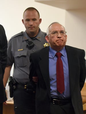 John Sandoval is escorted out of the courtroom after pleading guilty to second-degree murder at the Weld County Courthouse in Greeley, Colo., Friday, March 31. He led Greeley police to the remains of his wife Tina Tournai-Sandoval, last week in exchange for a lessor sentence.