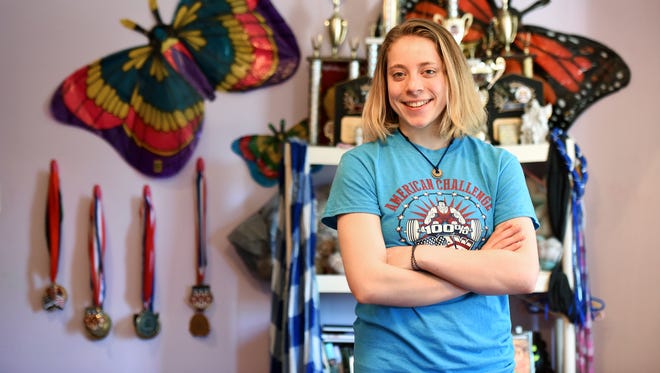 Powerlifter Naomi "Supergirl" Kutin, 15 with some of her medals in her bedroom.