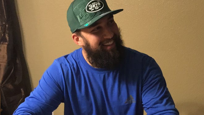Redding native Josh Latham smiles after signing a three-year contract with the New York Jets on Monday.