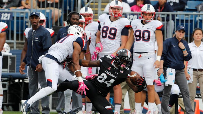 Cincinnati Bearcats wide receiver Nate Cole (84) makes the catch against Connecticut Huskies cornerback John Robinson IV (31) in the first quarter at Rentschler Field.