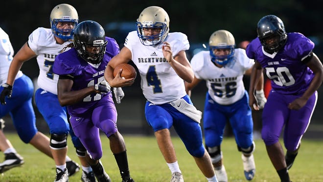 Brentwood quarterback Carson Shacklett (4) races up the field past the Cane Ridge defense during the second quarter at Cane Ridge High School Friday, Aug. 25, 2017 in Nashville, Tenn.
