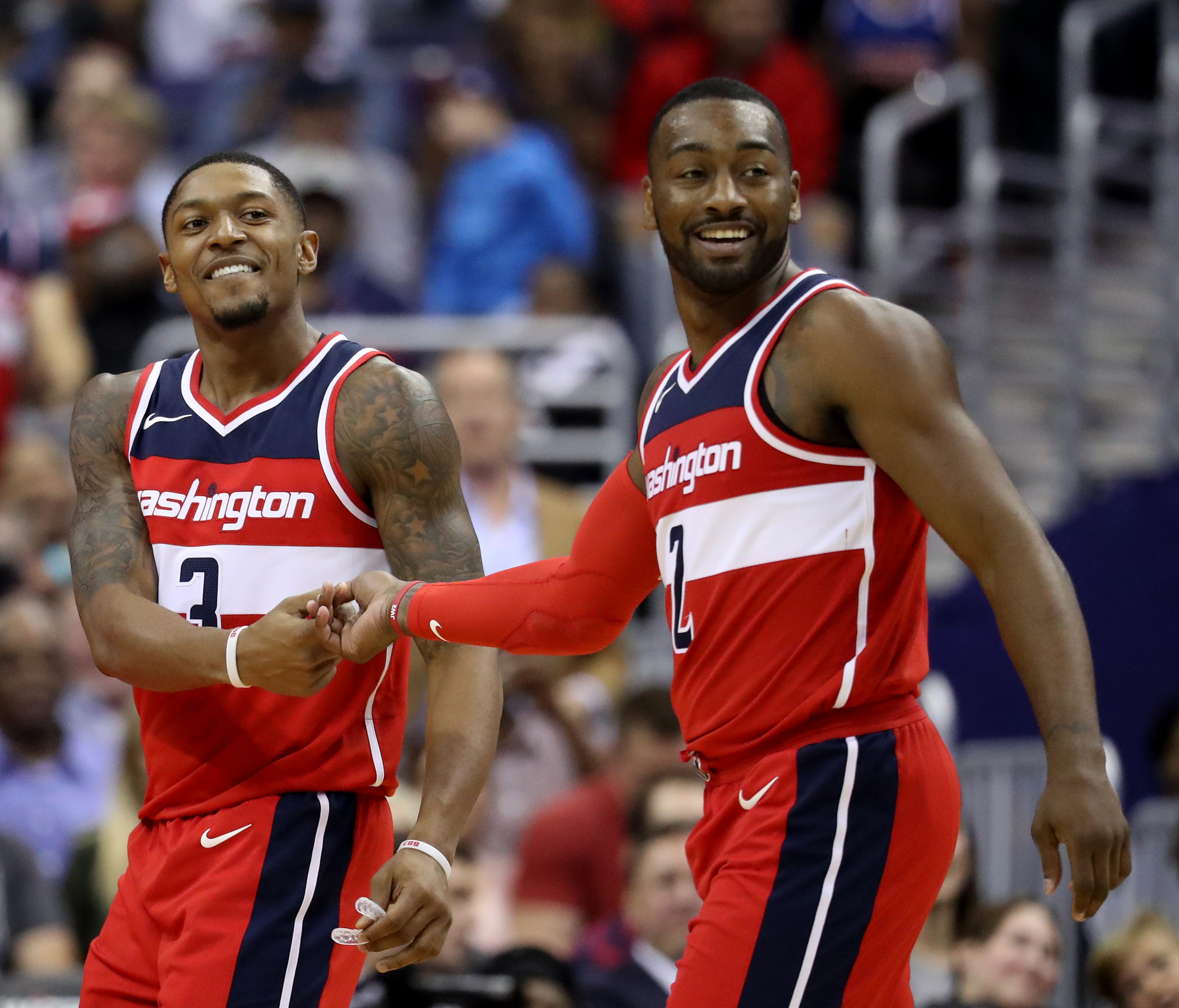 Bradley Beal and John Wall of the Washington Wizards celebrate in the second half against the Detroit Pistons at Capital One Arena.