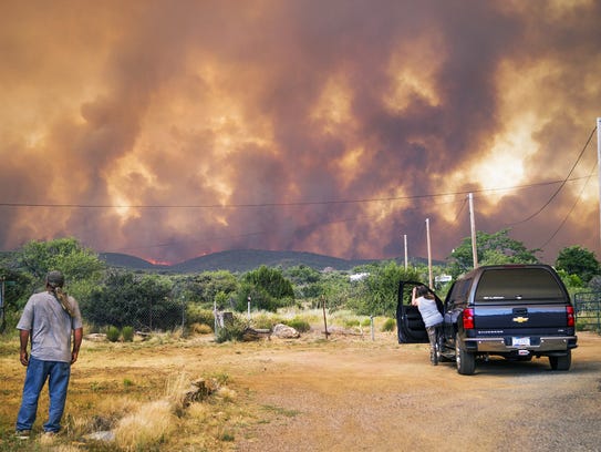 Don Sandy (left) watches the Goodwin Fire as seen from