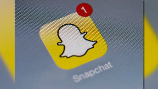 The logo of mobile app "Snapchat" is displayed on a tablet.