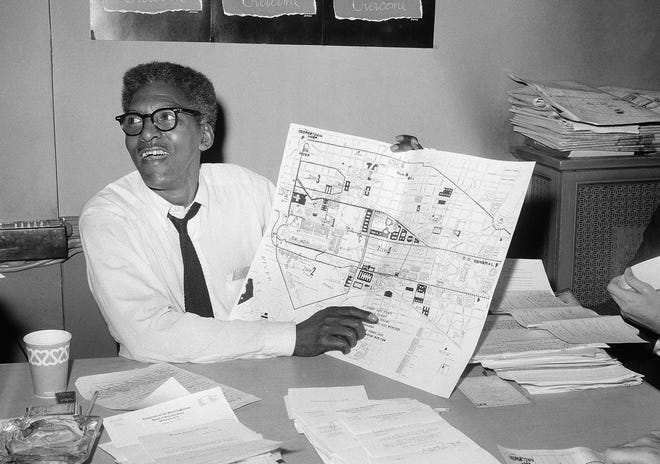 Bayard Rustin points to a map showing the line of the March on Washington in 1963.
