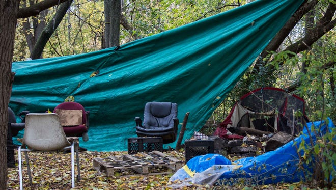 An assortment of chairs and a few tents in one of Battle Creek's homeless camps in 2014.