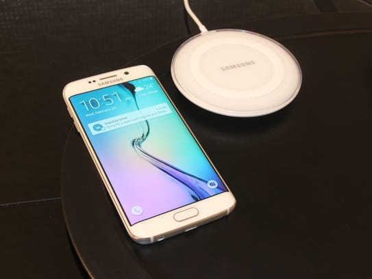 A Samsung Galaxy S6 Edge next to wireless charging