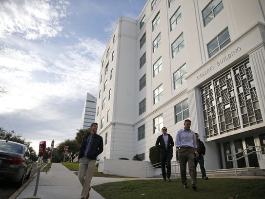 People leave the Collins Building the office of the