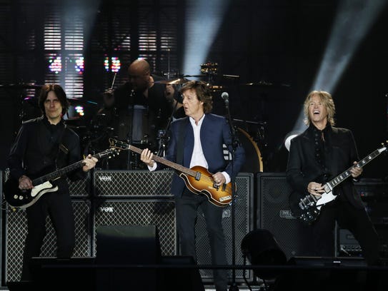 Paul McCartney (C) performs along with US musicians