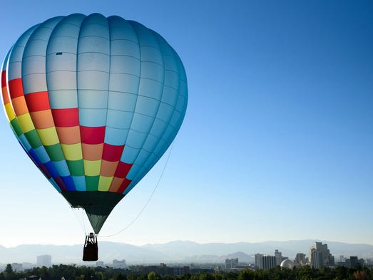A balloon flies above Reno during the Reno Balloon