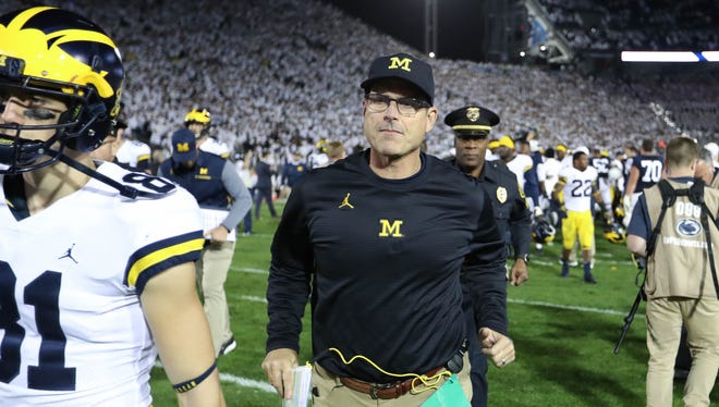 Michigan coach Jim Harbaugh leaves the field after the 42-13 loss to Penn State last season.