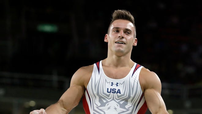 United States' Sam Mikulak celebrates after her performance on the parallel bars during the artistic gymnastics men's individual all-around final at the 2016 Summer Olympics in Rio de Janeiro, Brazil, Wednesday, Aug. 10, 2016.