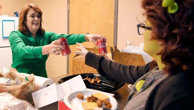 Page High School parent volunteer Kimberly Vice and other volunteers help feed dinner to Page High theatre students before play rehearsals at the school on Wednesday, March 8, 2018. 